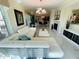 Bright and airy living room featuring a fireplace, marble floors, white couches and stylish decor at 1925 S Atlantic Ave # 411, Daytona Beach, FL 32118