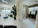 Bright open living room features tile floors, and views from windows and balcony at 1925 S Atlantic Ave # 411, Daytona Beach, FL 32118