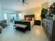 Bright main bedroom featuring stylish furniture, including a bed, dresser, chairs, and ceiling fan at 1925 S Atlantic Ave # 411, Daytona Beach, FL 32118