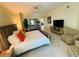 Bright main bedroom featuring stylish furniture, including a bed, dresser, chair, and ceiling fan at 1925 S Atlantic Ave # 411, Daytona Beach, FL 32118