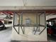 A secure storage cage in a parking garage, providing extra space for residents at 1925 S Atlantic Ave # 411, Daytona Beach, FL 32118