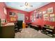 This bedroom features vibrant red walls adorned with various pictures and a ceiling fan at 2063 Killinger St, Deltona, FL 32738