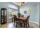 Elegant dining area with a large window, stylish light fixture, and laminate flooring at 2063 Killinger St, Deltona, FL 32738
