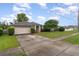 A single Gathering home with a well maintained lawn, a driveway, and mature trees at 2063 Killinger St, Deltona, FL 32738