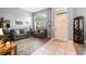 Bright living room with high ceilings, stylish sofas, and tile and wood laminate flooring at 2063 Killinger St, Deltona, FL 32738