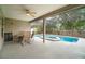 Covered outdoor dining area overlooking a private screened-in pool with a hot tub at 2063 Killinger St, Deltona, FL 32738