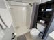 Bathroom featuring a shower stall and toilet, complete with functional shelves at 2357 Rio Pinar Lakes Blvd, Orlando, FL 32822