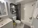 Standard white bathroom featuring a shower-tub combo, toilet, and shelving at 2357 Rio Pinar Lakes Blvd, Orlando, FL 32822