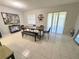 Bright dining room with a modern table set, a decorative mirror, and sliding glass doors to a patio at 2357 Rio Pinar Lakes Blvd, Orlando, FL 32822