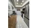 Galley kitchen featuring white cabinets, stainless steel appliances, and granite countertops at 2357 Rio Pinar Lakes Blvd, Orlando, FL 32822