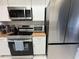 Modern kitchen appliances, granite countertops, and white cabinets at 2357 Rio Pinar Lakes Blvd, Orlando, FL 32822