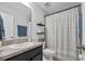 Bathroom with single sink vanity, toilet, and a shower with curtain at 2620 Waterline St, Kissimmee, FL 34743