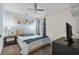 Comfortable bedroom featuring a queen-size bed, soft blue accents, and a ceiling fan at 2620 Waterline St, Kissimmee, FL 34743