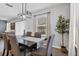 Cozy dining room with modern lighting, seating for six, and views of the backyard at 2620 Waterline St, Kissimmee, FL 34743