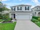 Charming two-story home with a well-manicured lawn, beautiful landscaping, and a two-car garage at 2620 Waterline St, Kissimmee, FL 34743