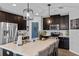 Spacious kitchen featuring a large island, quartz countertops, stainless steel appliances, and pendant lighting at 2620 Waterline St, Kissimmee, FL 34743