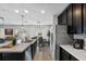 Open-concept kitchen featuring a large island, stainless steel appliances, and seamless flow to the dining area at 2620 Waterline St, Kissimmee, FL 34743