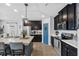 Beautiful kitchen with stainless steel appliances, dark cabinetry, and an island with barstool seating at 2620 Waterline St, Kissimmee, FL 34743