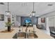 Bright, open-concept kitchen showcasing a large island with double sinks and pendant lighting, seamlessly flowing into the living space at 2620 Waterline St, Kissimmee, FL 34743