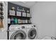 Well-organized laundry room with shelving, front load washer and dryer at 2620 Waterline St, Kissimmee, FL 34743