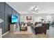 Comfortable living room with stylish furniture, modern ceiling fan, and a large TV screen displaying a tropical beach view at 2620 Waterline St, Kissimmee, FL 34743