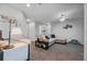Inviting living room area with cozy sectional sofa, stylish decor, and a ceiling fan at 2620 Waterline St, Kissimmee, FL 34743
