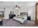Spacious main bedroom with a large bed, ceiling fan, dresser, and stylish decor at 2620 Waterline St, Kissimmee, FL 34743