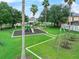 Neighborhood playground with a swing set, play equipment, mature trees and green space at 2620 Waterline St, Kissimmee, FL 34743