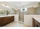 Bathroom featuring a glass-enclosed shower, a double vanity with dark wood cabinets and neutral paint at 2659 Magpie Way, Sanford, FL 32773