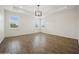 Light-filled bedroom with wood-look tile flooring and multiple windows bringing in natural light at 2659 Magpie Way, Sanford, FL 32773