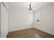 Cozy bedroom with closet, wood-look tile floor, and modern lighting at 2659 Magpie Way, Sanford, FL 32773