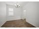 Bright bedroom featuring neutral paint, wood-look tile flooring and a contemporary light fixture at 2659 Magpie Way, Sanford, FL 32773