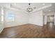 Bright bedroom with wood-look tile flooring and modern light fixture at 2659 Magpie Way, Sanford, FL 32773