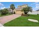 Lovely home exterior with brick driveway, green lawn, and mature trees creating an inviting curb appeal at 2659 Magpie Way, Sanford, FL 32773
