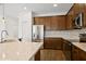 Modern kitchen features stainless steel appliances, granite countertops, and warm wood cabinetry at 2659 Magpie Way, Sanford, FL 32773