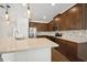 Modern kitchen features stainless steel appliances, granite countertops, and warm wood cabinetry at 2659 Magpie Way, Sanford, FL 32773