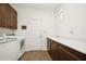 Laundry room with a utility sink, washer and dryer, and white countertops at 2659 Magpie Way, Sanford, FL 32773