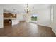 Open-concept living area with tile flooring, access to the pool, and adjacent modern kitchen at 2659 Magpie Way, Sanford, FL 32773