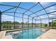 Gorgeous screened-in pool with lake view, blue tiling and inground seating at 2659 Magpie Way, Sanford, FL 32773