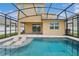 Lovely pool with lounge chairs, screened enclosure, and inviting patio area at 2659 Magpie Way, Sanford, FL 32773