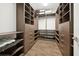 Spacious walk-in closet with custom shelving and wood-look tile flooring at 2659 Magpie Way, Sanford, FL 32773