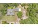 Overhead view of the home surrounded by lush trees and a large manicured lawn at 2691 Phillips Rd, Christmas, FL 32709