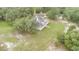 Overhead view of the home surrounded by lush trees and a large manicured lawn at 2691 Phillips Rd, Christmas, FL 32709