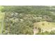 Aerial view showcasing the home's setting amongst sprawling greenery, providing privacy and a natural landscape at 2691 Phillips Rd, Christmas, FL 32709