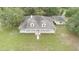 Aerial view of the charming single-story home with a wraparound porch and expansive green lawn at 2691 Phillips Rd, Christmas, FL 32709
