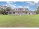Charming single-story home with a large, inviting wraparound porch and lush green lawn at 2691 Phillips Rd, Christmas, FL 32709