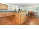 Open kitchen with an island, hardwood floors, and views into living room at 2691 Phillips Rd, Christmas, FL 32709