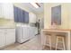 Functional laundry room featuring a washer, dryer, counter space, and cabinetry at 2691 Phillips Rd, Christmas, FL 32709