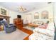 Spacious living room with hardwood floors, fireplace, and comfortable seating with archways to other rooms at 2691 Phillips Rd, Christmas, FL 32709