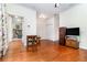 Open living room with hardwood floors and an inviting view into the den with a fireplace at 2691 Phillips Rd, Christmas, FL 32709